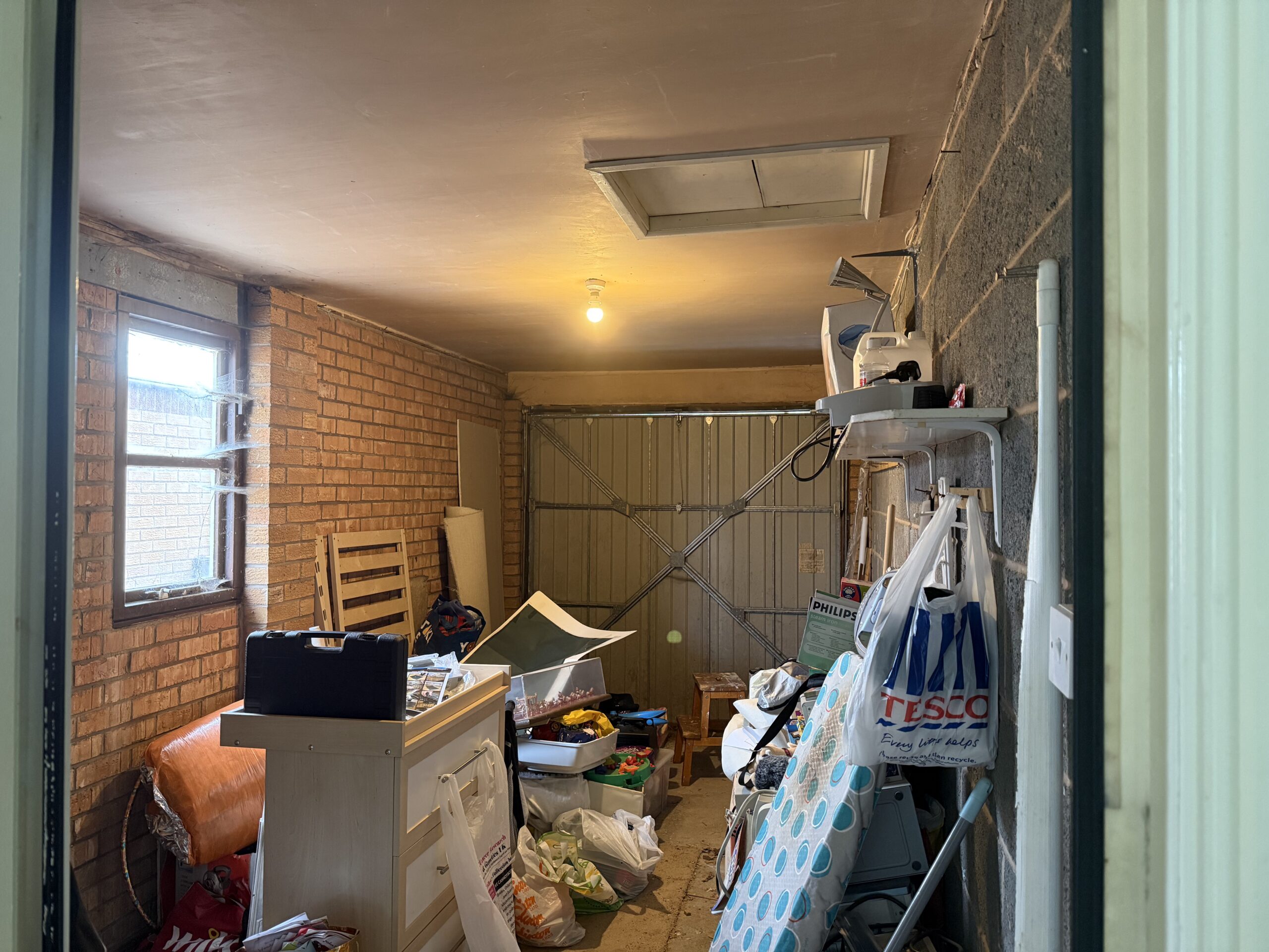 A partially cleared garage prior to conversion into a second reception room.